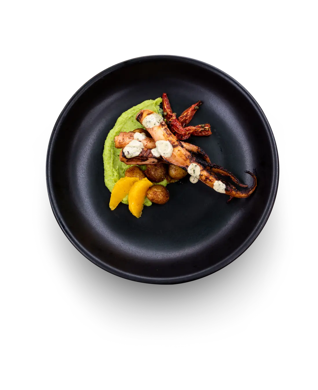 Grilled octopus, served with paprika potatoes and a smooth pea puree