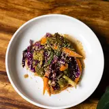 Bowl of fermented vegetables with red cabbage, carrot, sesame and peanut sauce