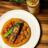 Catch of the day over sweet potato purée with cherry tomatoes