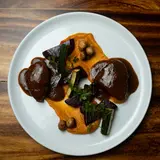 Chicken in tamarind sauce over carrot cream, with beetroot and zucchini