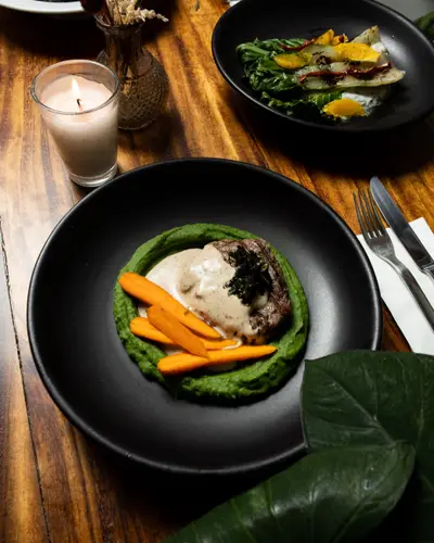 A table set at Rosanta with dishes, candles and dried flowers